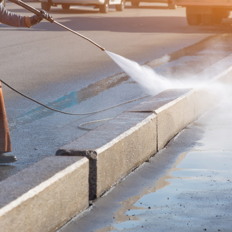 someone pressure washing concrete